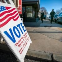 Voters filing in and out at the Allston branch of the Boston Public Library. (Jesse Costa/WBUR)