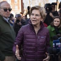 Sen. Elizabeth Warren talks to the press after announcing that she was dropping out of the Democratic presidential race. (Robin Lubbock/WBUR)