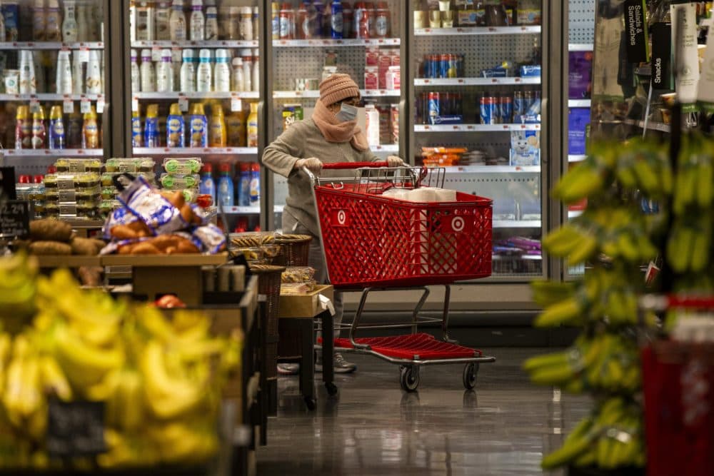A woman wearing a face mask shopping at Target in Watertown, Mass., March 18, 2020. (Jesse Costa/WBUR)