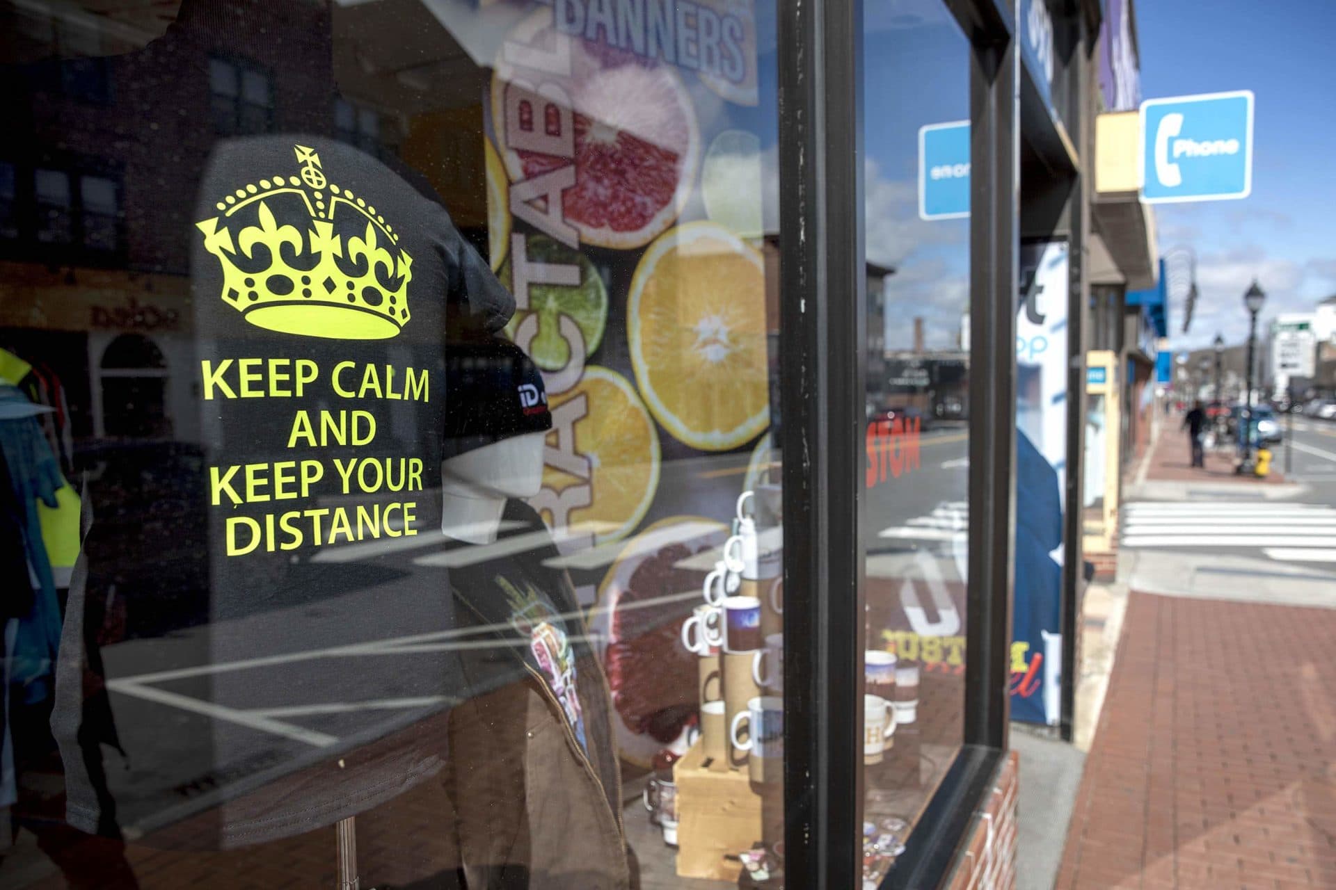 A T-shirt in the window of the iD art GraphicsShop on Moody Street, Waltham, says "Keep Calm And Keep Your Distance." (Robin Lubbock/WBUR)