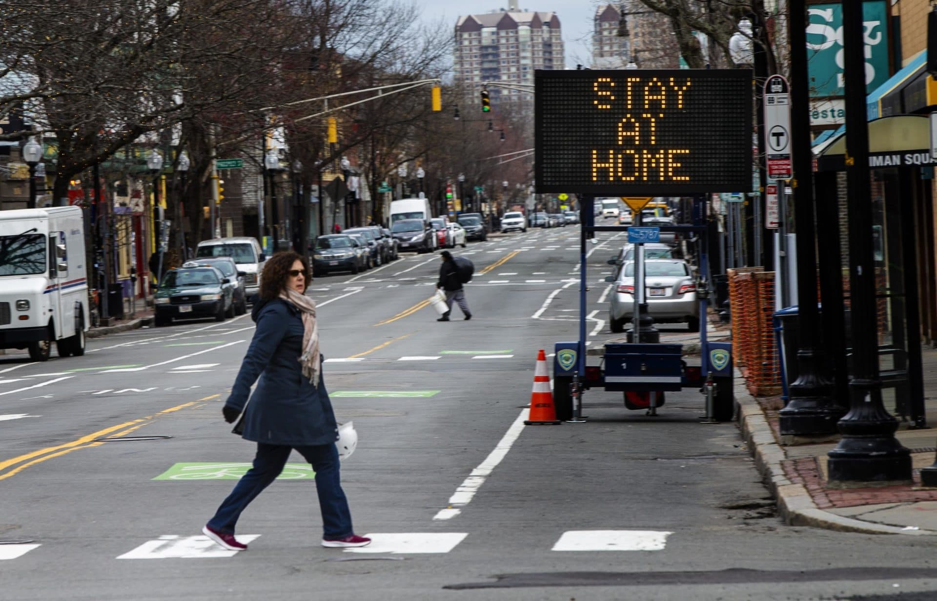 A sign in Inman Square in Cambridge urging residents to stay home during the coronavirus pandemic. (Jesse Costa/WBUR)