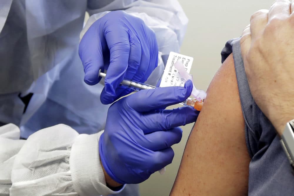 Neal Browning receives a shot in the first-stage safety study clinical trial of a potential vaccine for COVID-19, the disease caused by the new coronavirus, at the Kaiser Permanente Washington Health Research Institute in Seattle. (Ted S. Warren/AP)