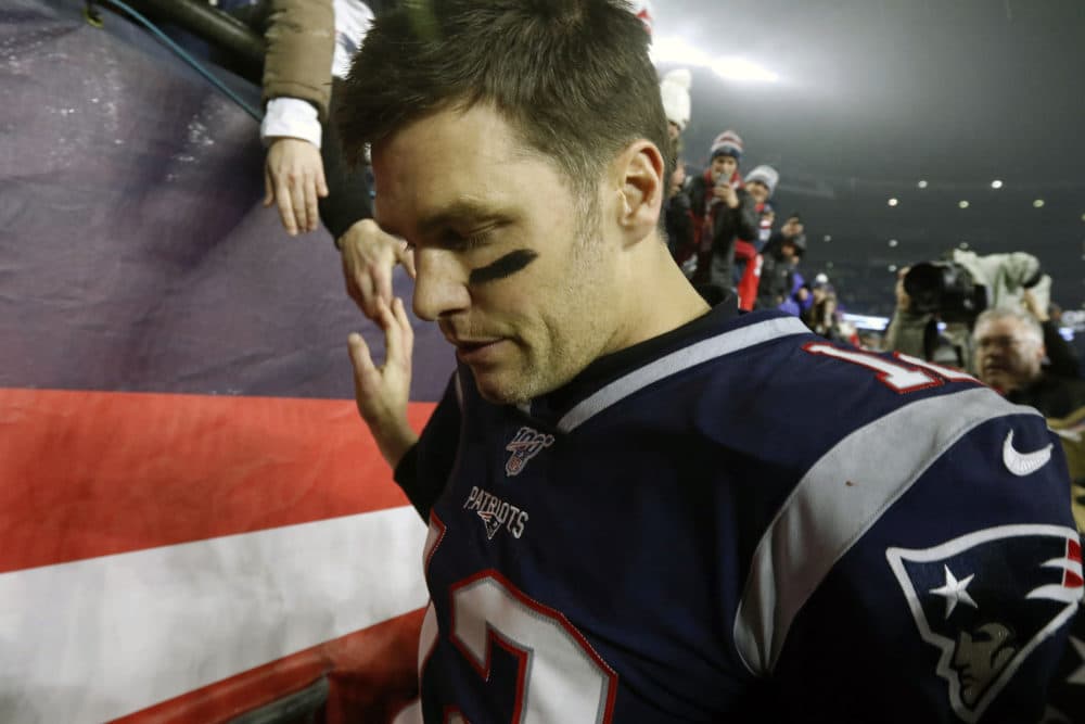 In this Jan. 4, 2020, file photo, New England Patriots quarterback Tom Brady shakes hands with a fan as he leaves the field after losing an NFL wild-card playoff football game to the Tennessee Titans in Foxborough, Mass. Tom Brady is an NFL free agent for the first time in his career. The 42-year-old quarterback with six Super Bowl rings  said Tuesday morning, March 17, 2020, that he is leaving the New England Patriots. (Bill Sikes/AP)