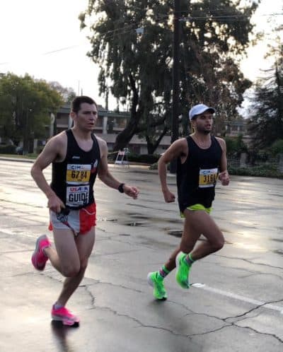 Chaz Davis, right, runs with a guide. (Courtesy of Adaptive Sports New England)