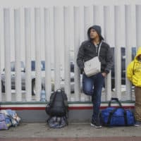 Honduran migrants wait in line to plead their asylum cases at the El Caparral border crossing on March 2, 2020 in Tijuana, Mexico. (Sandy Huffaker/Getty Images)