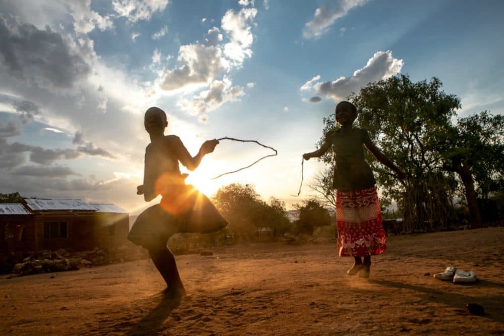 Alice Kanjinga (left), 6, jumps rope at her family's home in Kamdzandi Village, near PIH-supported Lisungwi Community Hospital in Neno District, Malawi. (Karin Schermbrucker/ Partners In Health)