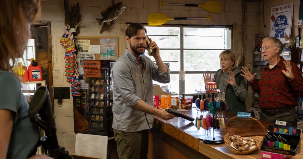 Ike Barinholtz, center, in "The Hunt." (Courtesy Universal Pictures)