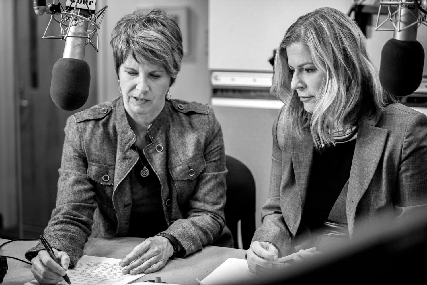 Beth Healy (L) & Christine Willmsen (R) at work (Liz Linder/WBUR)