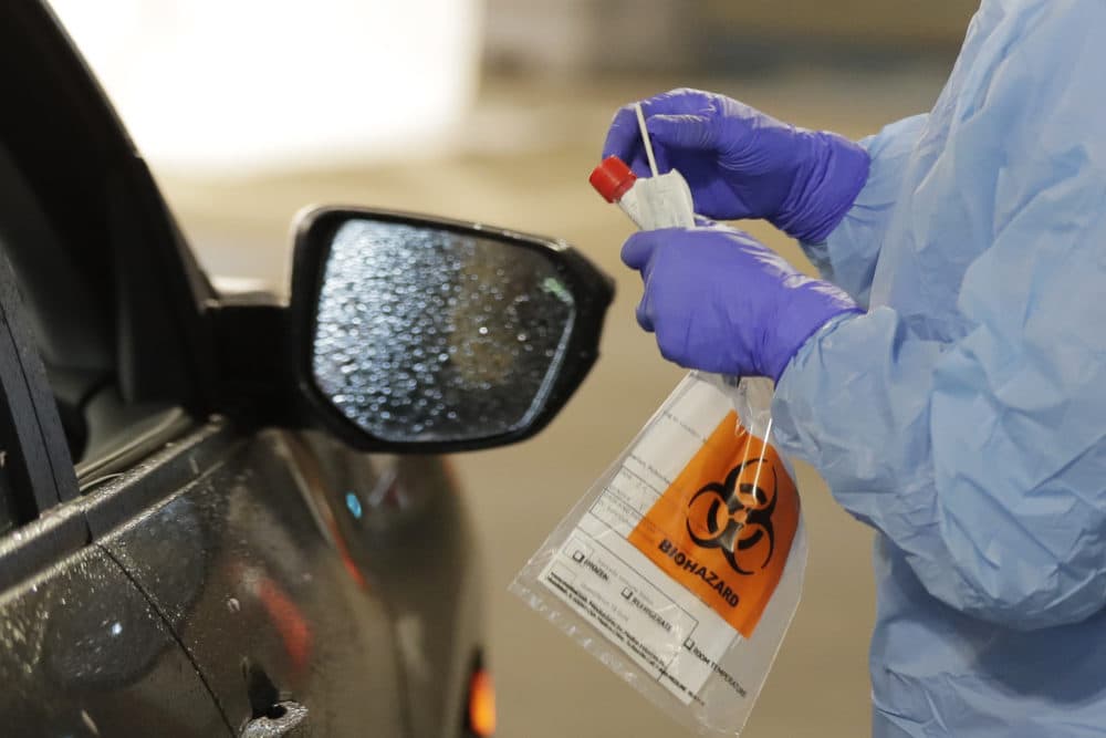 A nurse at a drive up COVID-19 coronavirus testing station, set up by the University of Washington Medical Center, on Friday, March 13, in Seattle. (Ted S. Warren/AP)
