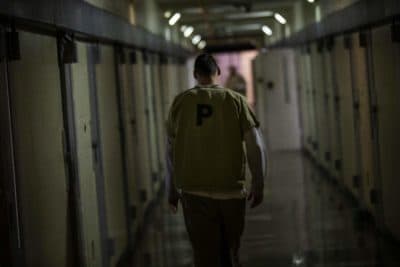 An inmate walks down one of the hallways of Worcester County jail. (Jesse Costa/WBUR)