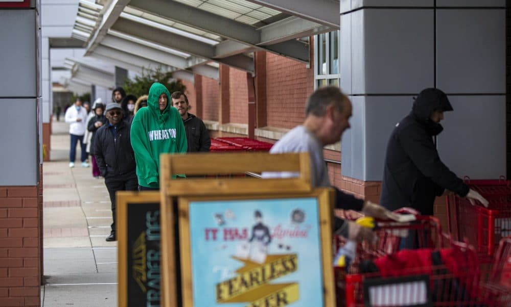 A long line of people wait to gain entrance into Trader Joe’s in Assembly Square. (Jesse Costa/WBUR)