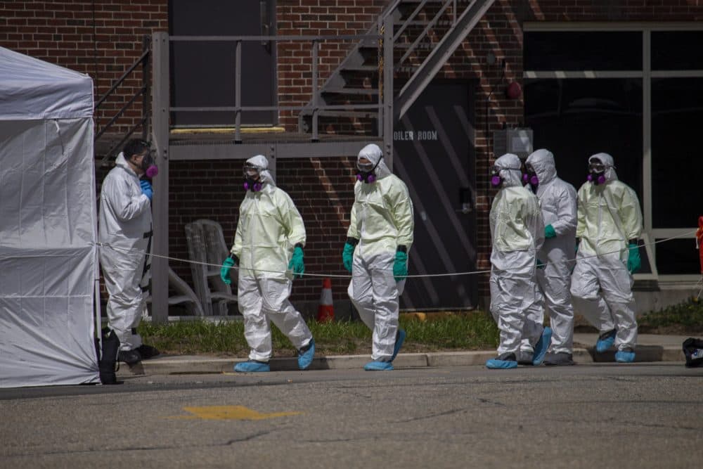 A cleaning crew suited up with protective gear enters the Soldiers' Home in Holyoke last month. (Jesse Costa/WBUR)