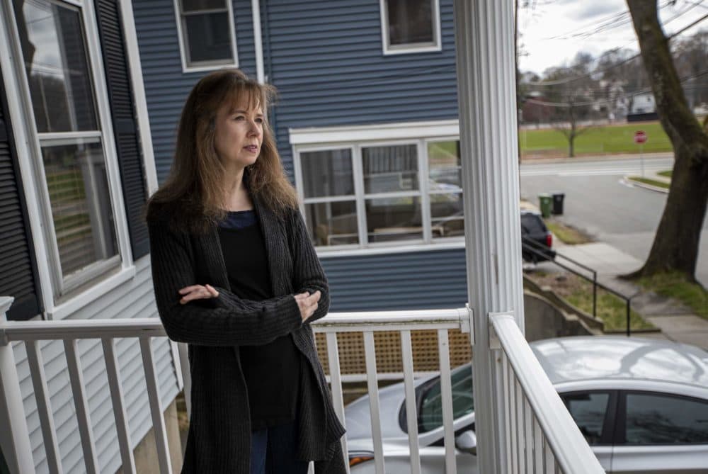 Phyllis Rittner, standing on her porch in Watertown, says the coronavirus pandemic has triggered certain aspects of her PTSD and anxiety. (Jesse Costa/WBUR)