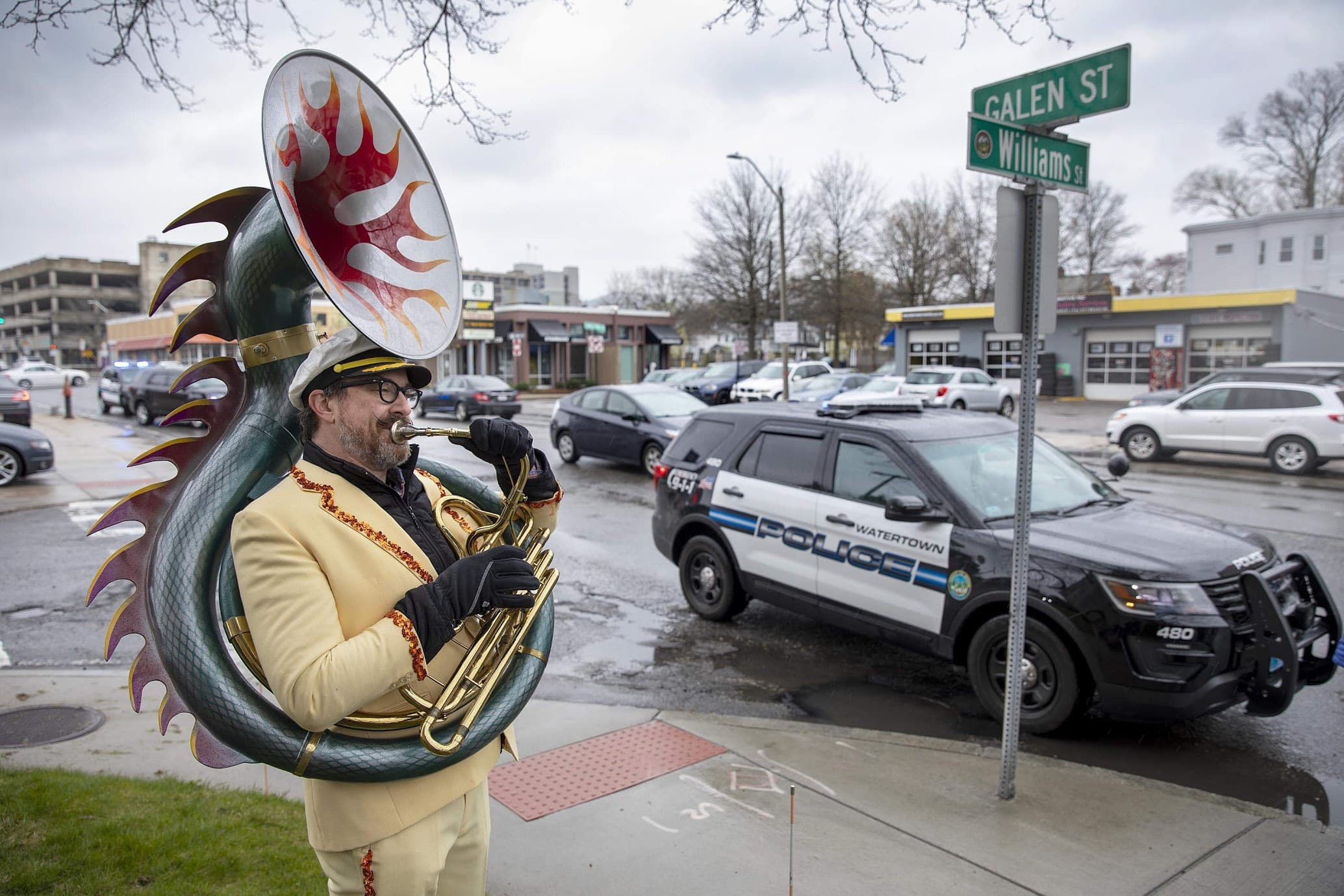 Sousaphone player Zachariah Hickman makes an appearance at Joe Markarian's birthday celebration on Galen Street. (Robin Lubbock/WBUR)