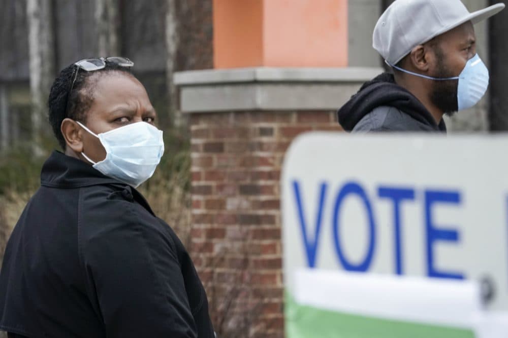 Voters line up at Riverside High School for Wisconsin's primary election Tuesday April 7, 2020, in Milwaukee. The new coronavirus causes mild or moderate symptoms for most people, but for some, especially older adults and people with existing health problems, it can cause more severe illness or death. (Morry Gash/AP)