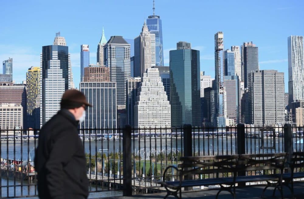 A man wearing a face mask takes a walk on the Brooklyn Heights Promenade on March 24, 2020 in New York. (Angela Weiss/AFP/Getty Images)
