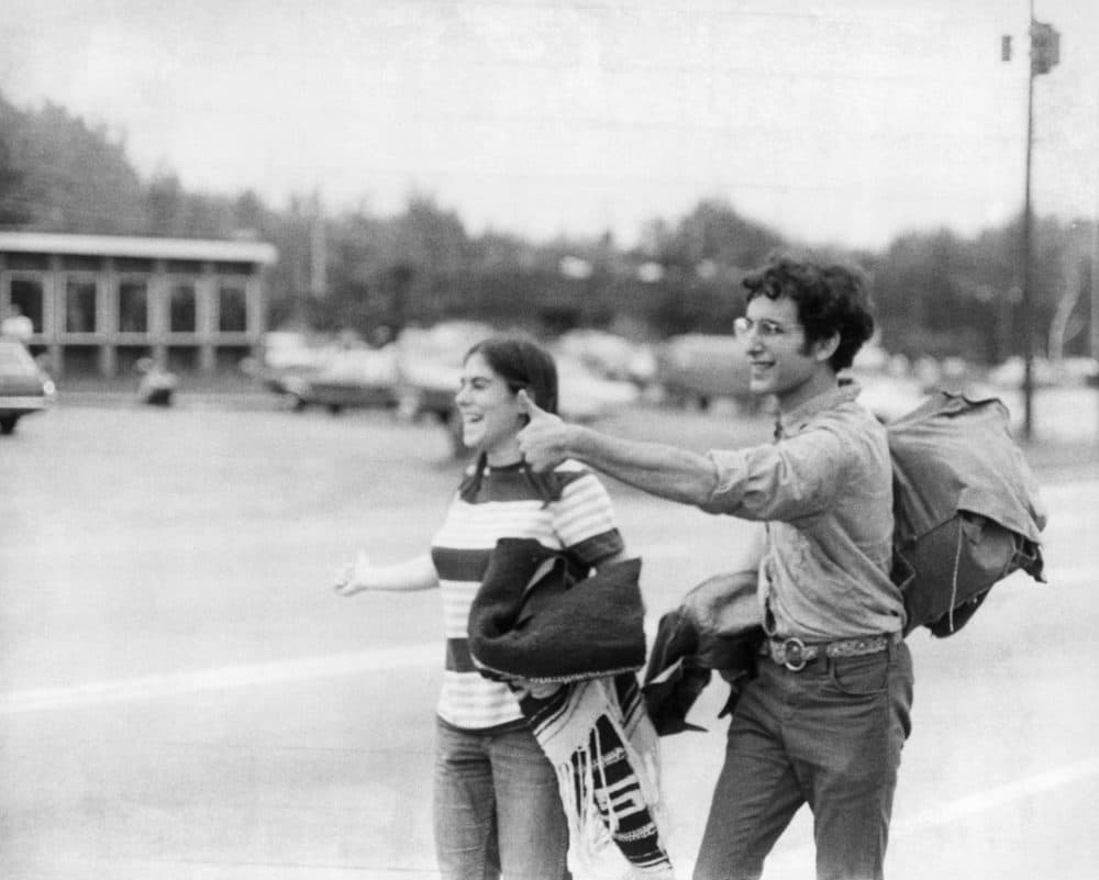 Faced with a ten mile walk in the mud to White Lake, followed by three more miles to the Woodstock pop festival in New York State, a couple turn back and hitch-hike home. (Three Lions/Getty Images)