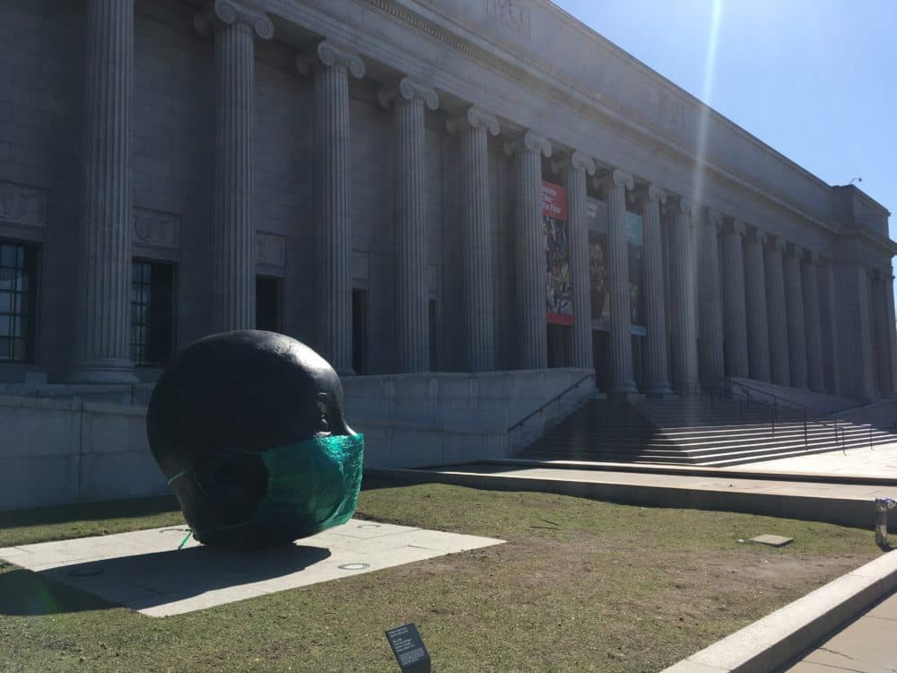 In a guerilla art installation, Boston artist Peter Agoos placed a supersized surgical mask he created over Antonio López García’s sculpture “Day,” which stands outside the Museum of Fine Arts. (Courtesy Peter Agoos)