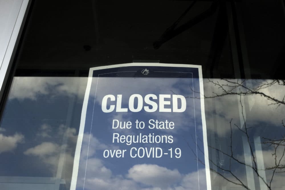 In this April 22 photo a closed sign is posted in the window of a store because of the coronavirus in an outdoor mall in Dedham. (Steven Senne/AP)