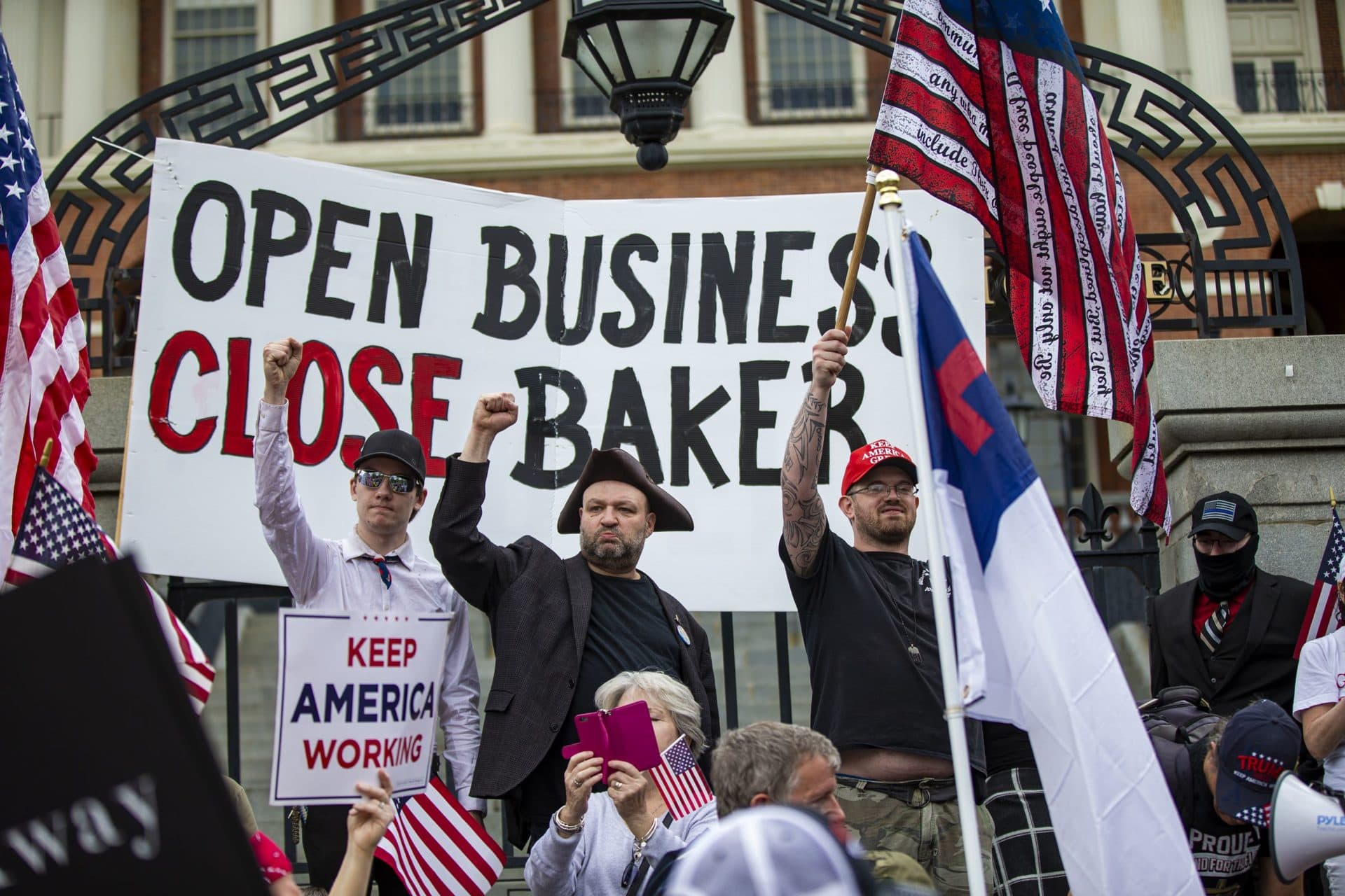 John Hugo, center, founder of Super Happy Fun America, cheers in front of the State House. Super Happy Fun America was the organization behind the "Straight Pride" parade in Boston in August 2019. (Jesse Costa/WBUR)