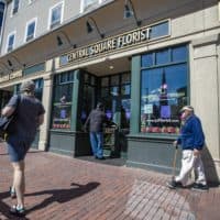 A prospectve patron attempts to open the front door of Central Square Florist in Cambridge, which is not open for in-store or curbside business, but only for contactless delivery, now that the COVID-19 restrictions for some non-essential businesses in Massachusetts have been lifted. (Jesse Costa/WBUR)