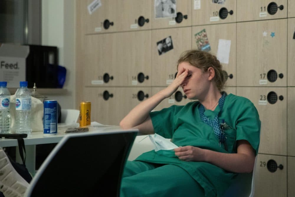 Mathilde Dumont, a 27-year-old nurse, reacts to tiredness early on April 11, 2020, during her night shift in the intensive care unit exclusively for COVID-19 patients at the Ixelles Hospital in Brussels, amid the COVID-19 pandemic, caused by the novel coronavirus. (Aris Oikonomou/AFP via Getty Images)