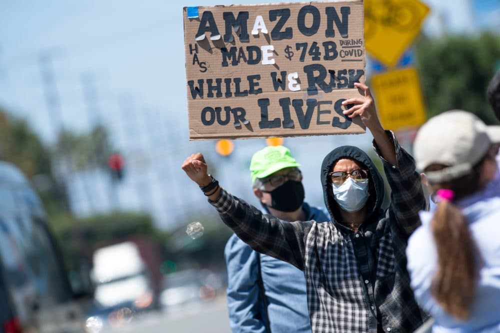 Workers protest the failure of their employers to provide adequate protections in the workplace of the Amazon delivery hub on National May Day Walkout/Sickout amid the Covid-19 pandemic on May 1, 2020, in Hawthorne, California. (VALERIE MACON/AFP via Getty Images)