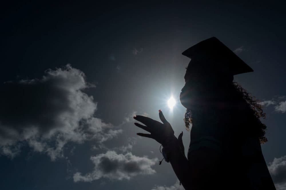 A graduating student wears a facemask during a symbolic graduation in cars to maintain social distance in Las Piedras, Puerto Rico. (Photo by Ricardo Arduengo/AFP/Getty Images)