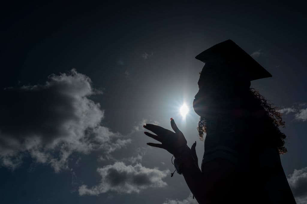 A graduating student wears a facemask during a symbolic graduation in cars to maintain social distance in Las Piedras, Puerto Rico. (Photo by Ricardo Arduengo/AFP/Getty Images)