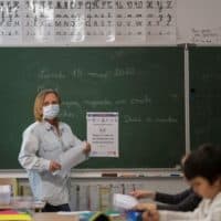 What does school look like in other parts of the world? A teacher gives a lesson at the Cour de Lorraine elementary school in Mulhouse, eastern France, on its re-opening day for pupils, on May 18, 2020. (SEBASTIEN BOZON/AFP via Getty Images)