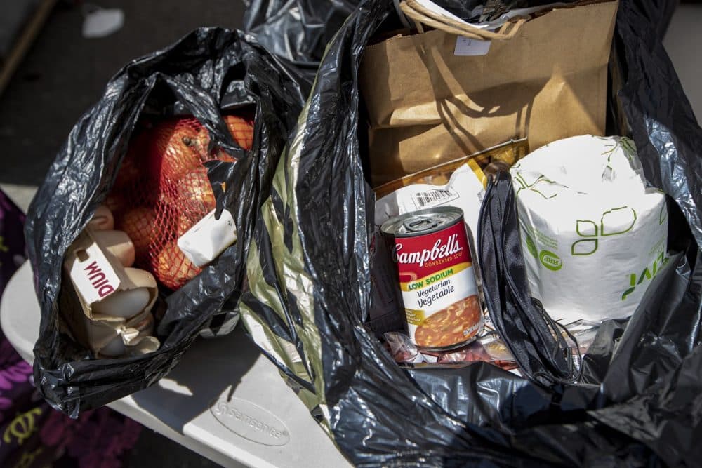 The bags of groceries given out at Rosie's Place include eggs, flour, canned goods and toilet paper. (Jesse Costa/WBUR)