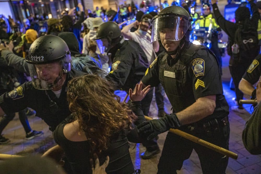 Boston Police move to clear out protesters on Washington Street at Downtown Crossing. (Jesse Costa/WBUR)