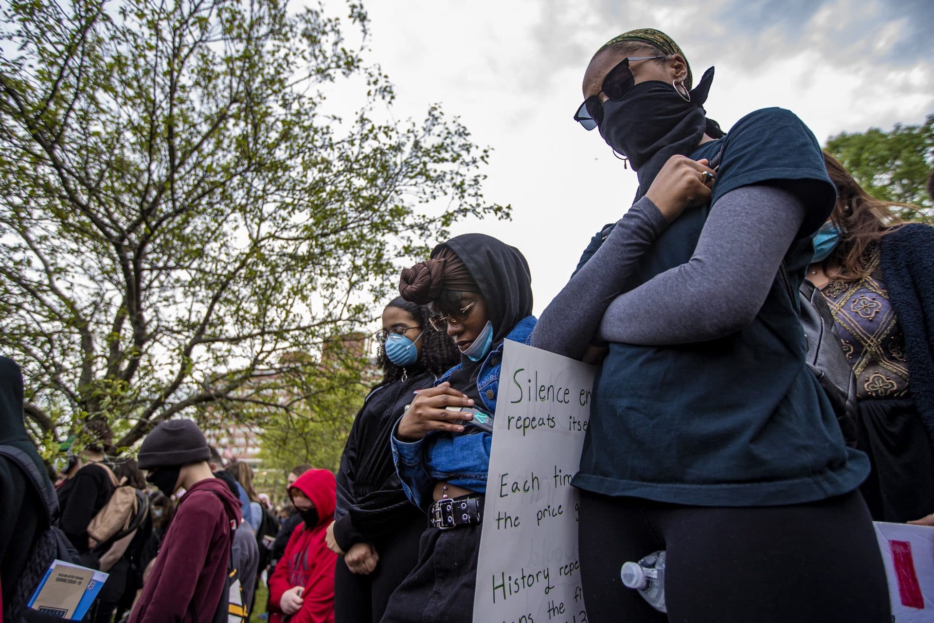 Protesters stood for a moment of silence during the vigil. (Jesse Costa/WBUR)