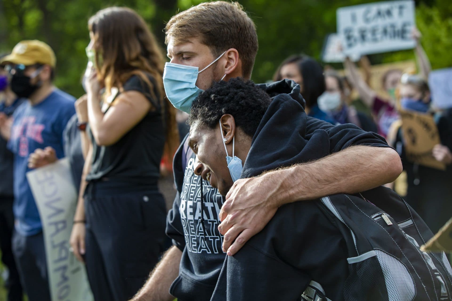Charlie St. Pierre embraces his friend Jacque Jackson during a moving speech. (Jesse Costa/WBUR)