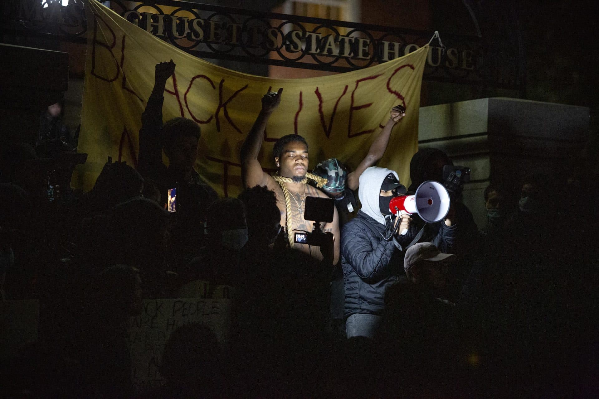 The protest continued late into the night at the gates of the Massachusetts State House. (Robin Lubbock/WBUR)