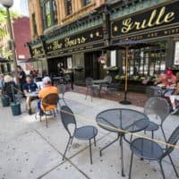 Diners eat lunch and have a few drinks at The Fours near North Station on the first day of phase two of reopening, allowing restaurants to serve patrons outdoors.(Jesse Costa/WBUR)
