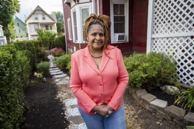 Dorothy Williams standing behind her home where she runs a daycare in Dorchester. (Jesse Costa/WBUR)