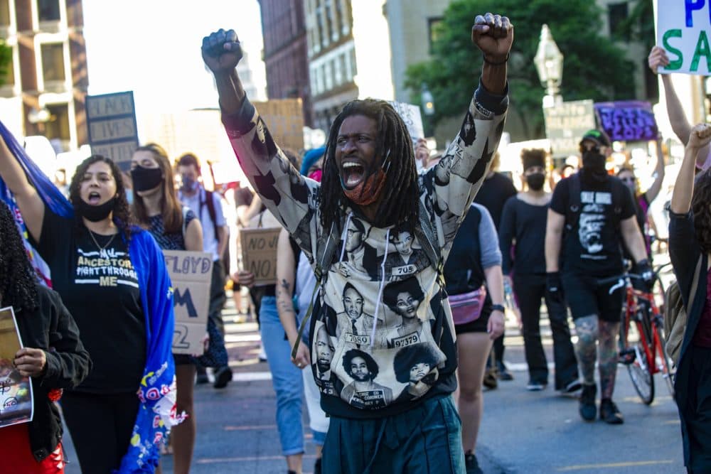 About two hundred protesters march down Tremont Street during a rally demanding an end police violence. (Jesse Costa/WBUR)
