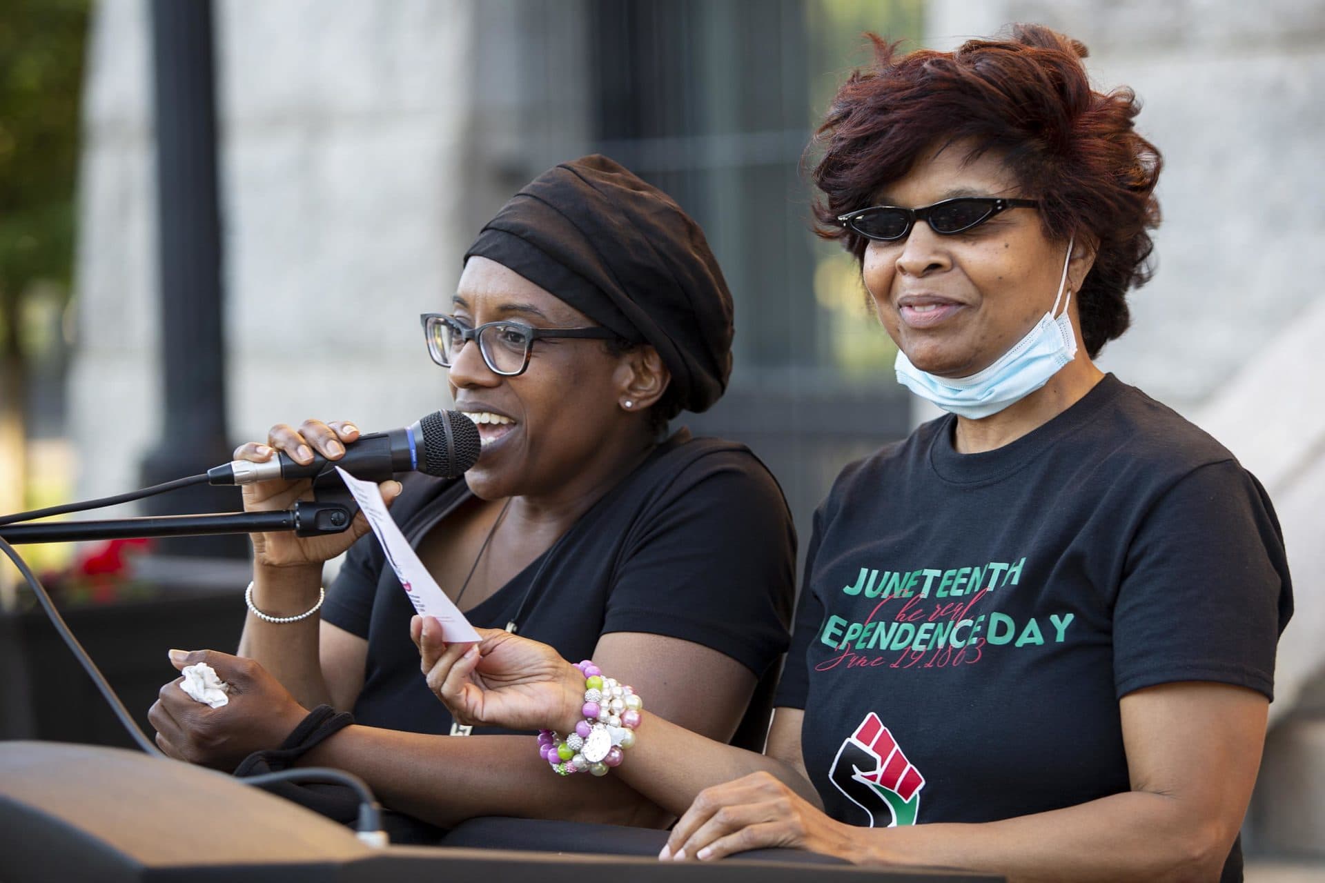 Coordinators Amy Washington-Winston and Jacqueline Jones lead an affirmation at the Juneteenth gathering at Brockton City Hall. (Robin Lubbock/WBUR)