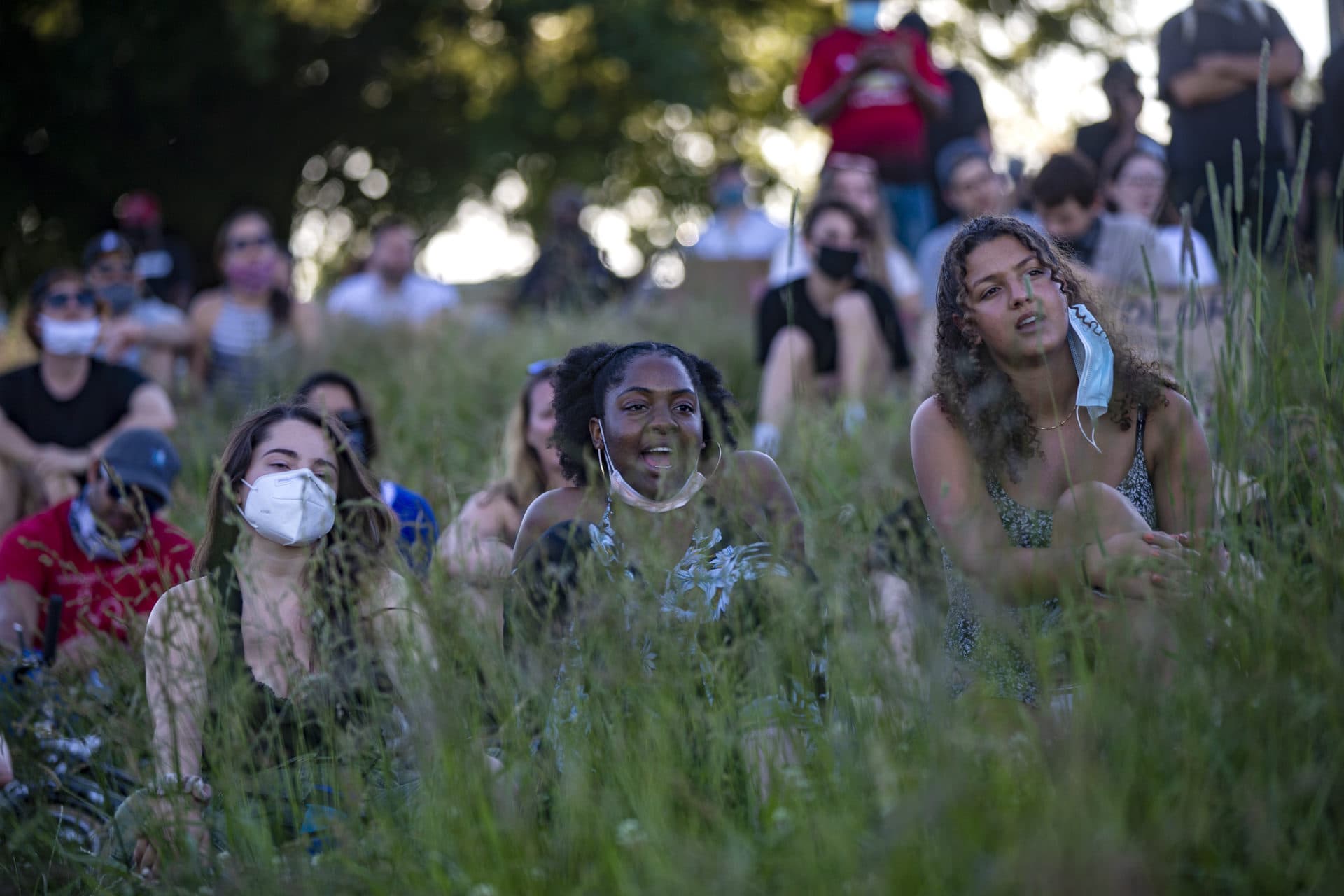 Rally participants chant with event organizer Brock Satter at the Funk The Police rally at Ronan Park in Dorchester. (Jesse Costa/WBUR)