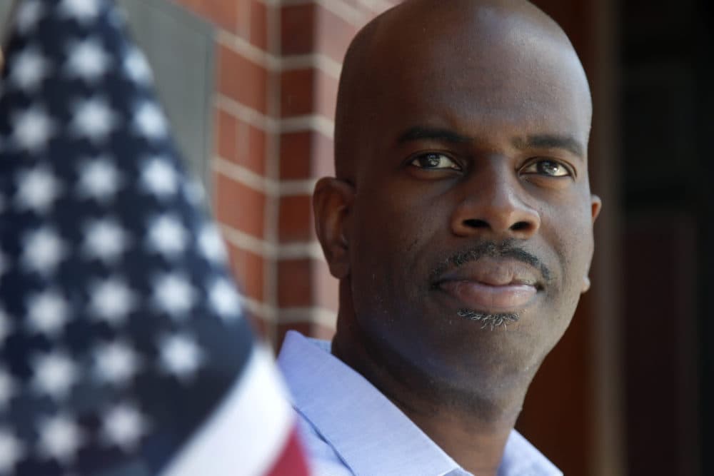 Gregory Minott stands in front of Town Hall in Andover, Mass. Minott came to the U.S. from his native Jamaica more than two decades ago on a student visa and was able to carve out a career in architecture thanks to temporary work visas. Now a U.S. citizen and co-founder of a real estate development firm in Boston, he worries that new restrictions on student and work visas expected to be announced soon will prevent others from following a similar path to the American dream. (Elise Amendola/AP)