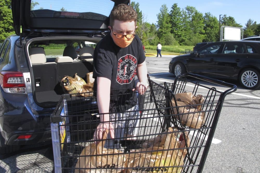 In this June 18, 2020, photo, Steve Picazio loads groceries into his car at Shaw's grocery store in Berlin, Vt. Vermont's ban on single-use plastic bags takes effect July 1, while some other states have postponed theirs amid the coronavirus pandemic. (AP Photo/Lisa Rathke)