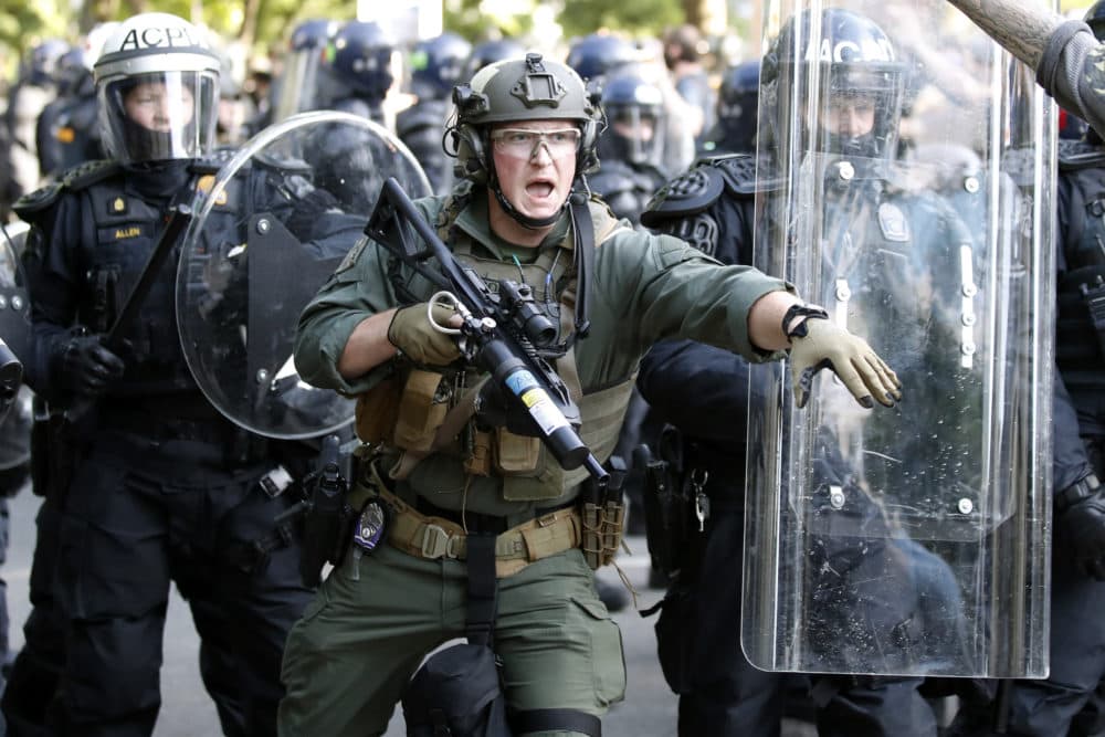 In this June 1, 2020, file photo police begin to clear demonstrators gathered as they protest the death of George Floyd near the White House in Washington. Floyd died after being restrained by Minneapolis police officers. (Alex Brandon/AP)