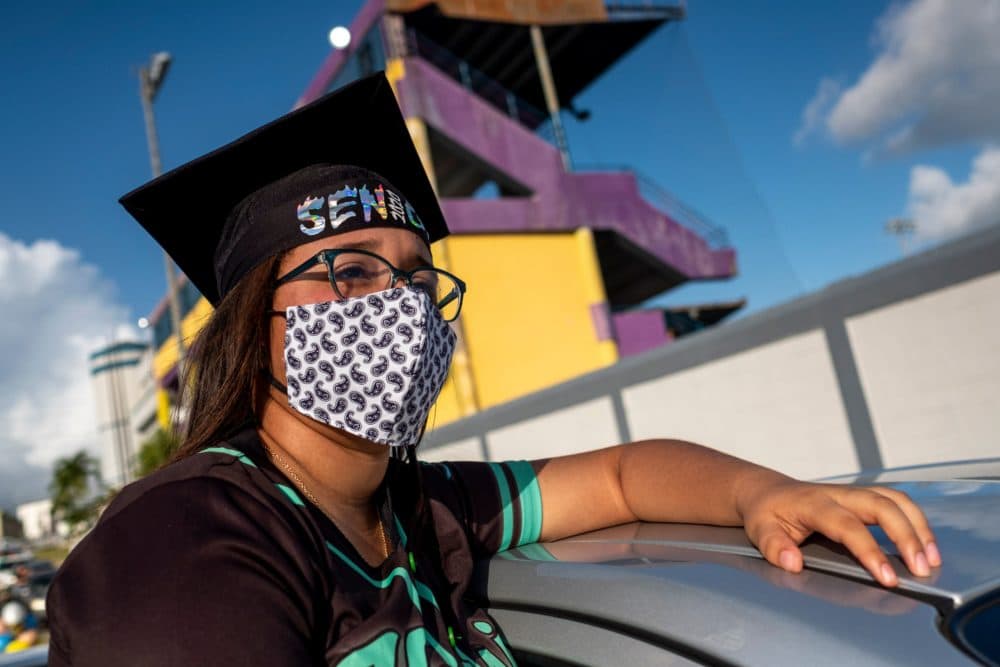 A graduating student from the Ramon Power Y Giralt High School attends a symbolic graduation from inside her car to maintain social distance at a parking lot in Las Piedras, Puerto Rico, on May 13, 2020. (RICARDO ARDUENGO/AFP via Getty Images)