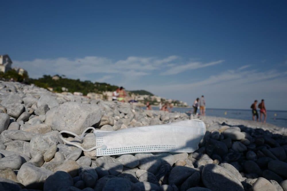 A face mask lies on a reopened beach in Nice, French Riviera after weeks of closure as part of the measures to curb the spread of COVID-19. (Valery Hache/AFP/Getty Images)