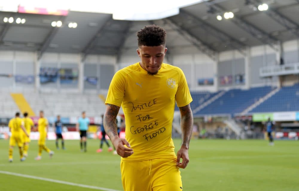 Dortmund's English midfielder Jadon Sancho wears a "Justice for George Floyd" shirt after scoring his team's third goal during a Bundesliga match on May 31, 2020. (Lars Baron/POOL/AFP via Getty Images)
