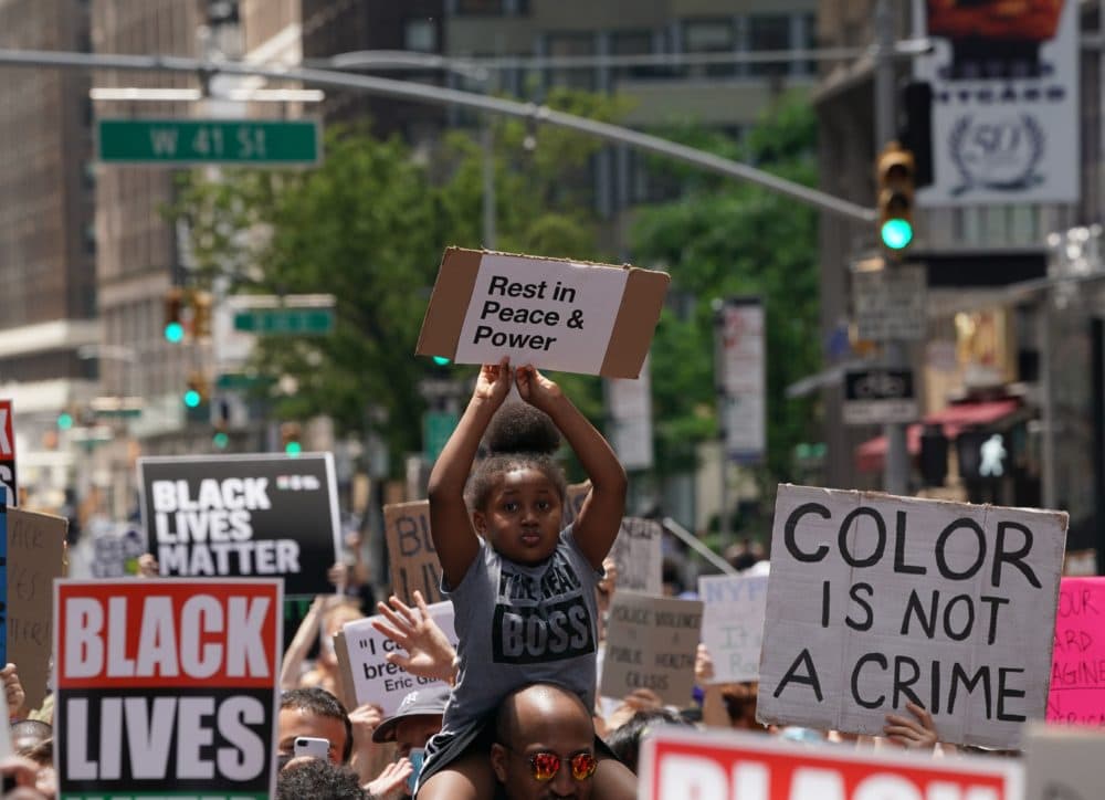 A little girl holds up a sign as "Black Lives Matter" New York protesters demonstrate in Times Square over the death of George Floyd by a Minneapolis police officer. (Bryan R. Smith/AFP/Getty Images)