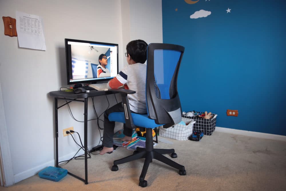 Seven-year-old Hamza Haqqani, a 2nd grade student at Al-Huda Academy, uses a computer to participate in an E-learning class with his teacher and classmates while at his home on May 01, 2020 in Bartlett, Illinois. (Scott Olson/Getty Images)