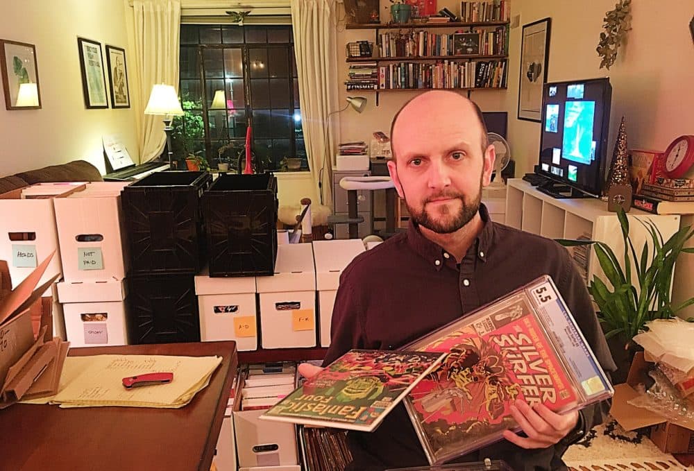 Matt Marlin shows off a few of his "grail" comic books at his home in Boston. (Courtesy)