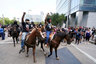 People march and ride horses to protest the death of George Floyd in Houston on Tuesday, June 2, 2020. Floyd died after a Minneapolis police officer pressed his knee into Floyd's neck for several minutes even after he stopped moving and pleading for air. (AP Photo/David J. Phillip)